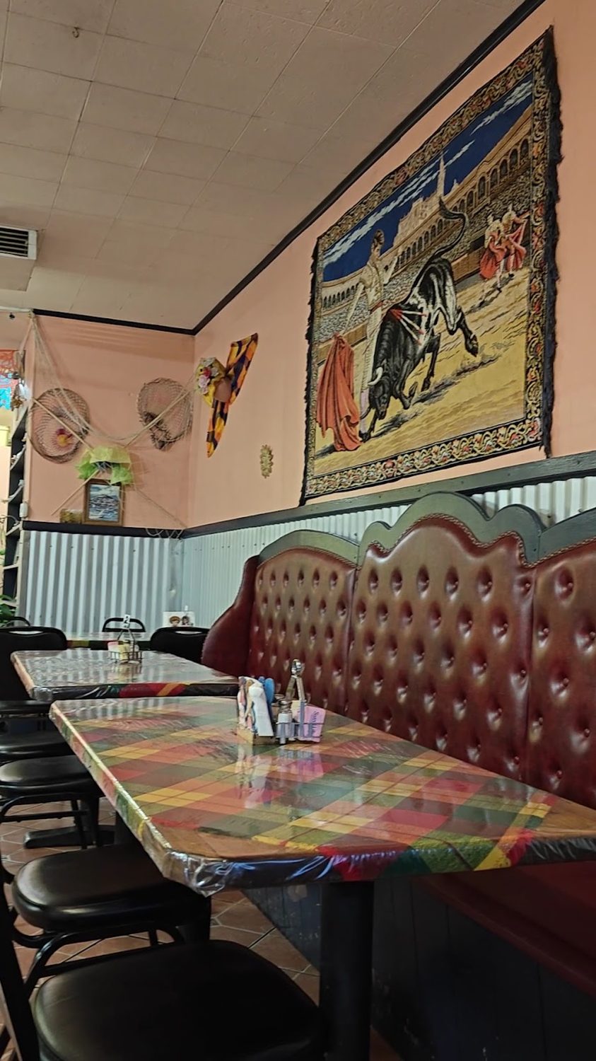 Red booth seating and murals inside Janitzio